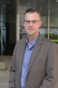 A close up photo of Josh Gordon in a gray suit.